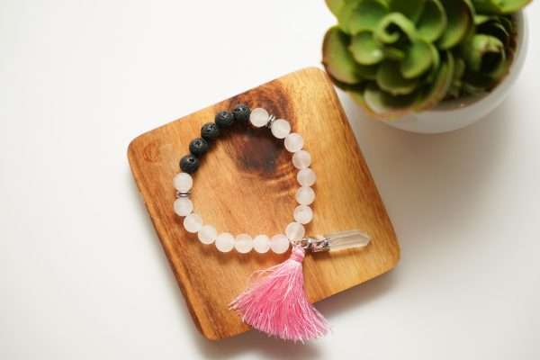Rose Quartz Bracelet finished with Lava Beads on a wooden plate
